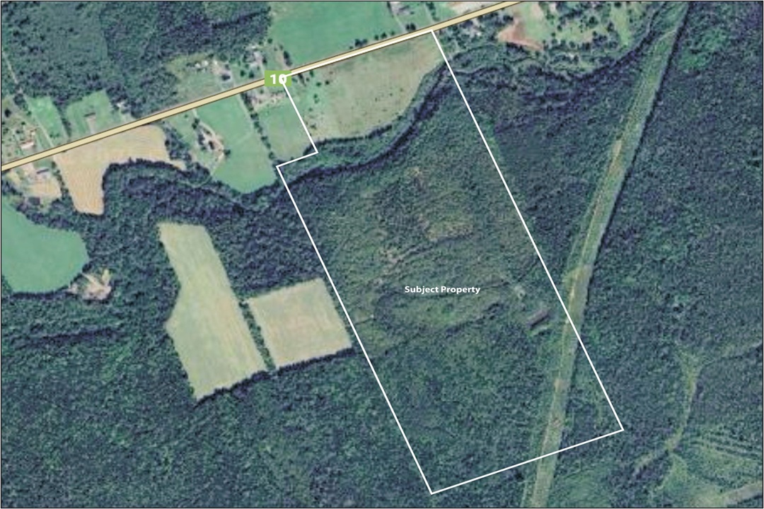 Aerial view of land area captured by satellite, displaying terrain and surroundings.