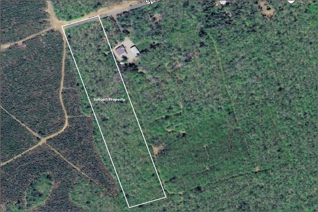 Aerial view of land area captured by satellite, displaying terrain and surroundings.