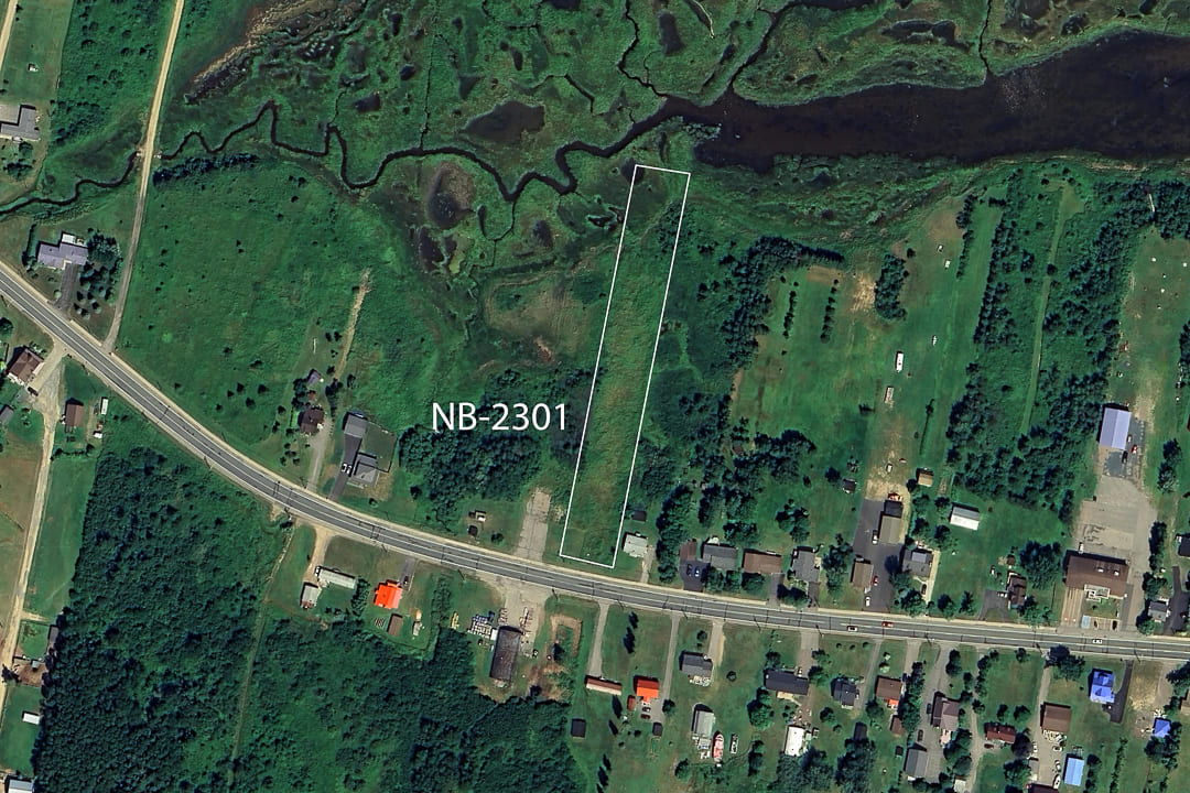 Aerial view of land area captured by satellite, displaying terrain and surroundings.