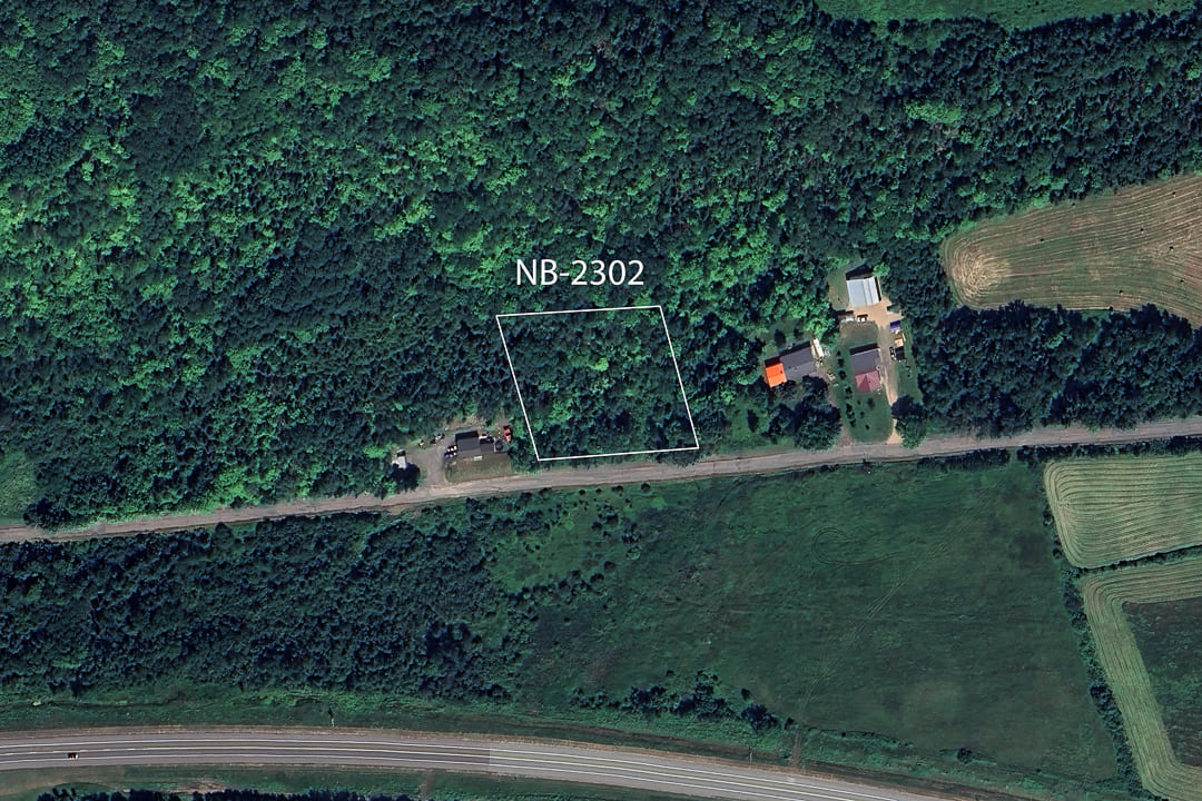 Aerial view of land area captured by satellite, displaying terrain and surroundings.