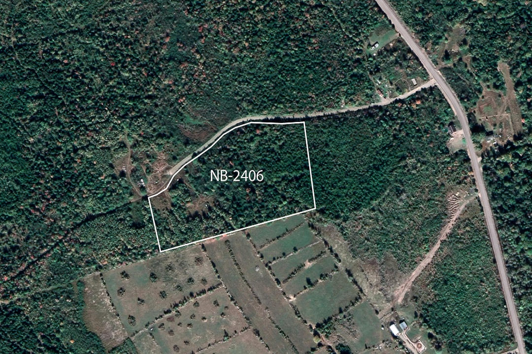 Aerial view of land area captured by satellite, displaying terrain and surroundings.